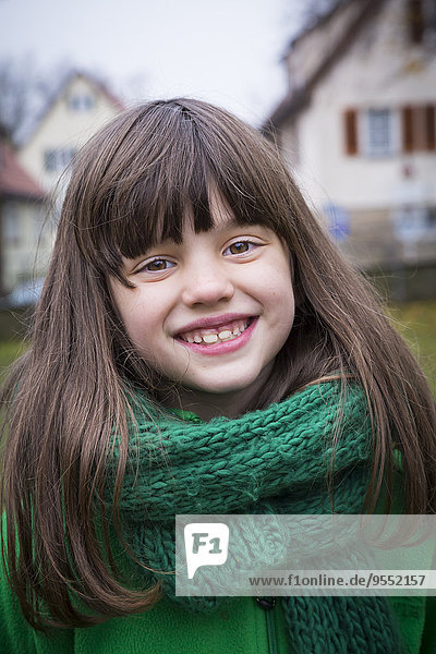 Portrait of smiling girl wearing green scarf