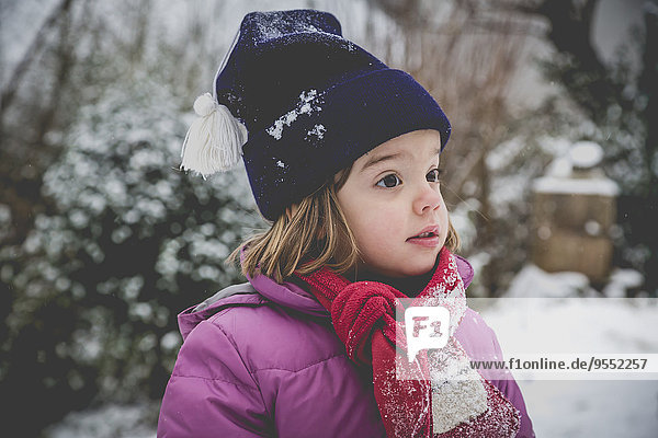Portrait of astonished little girl in winter