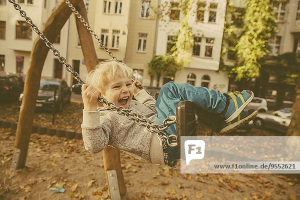 Toddler having fun on a swing