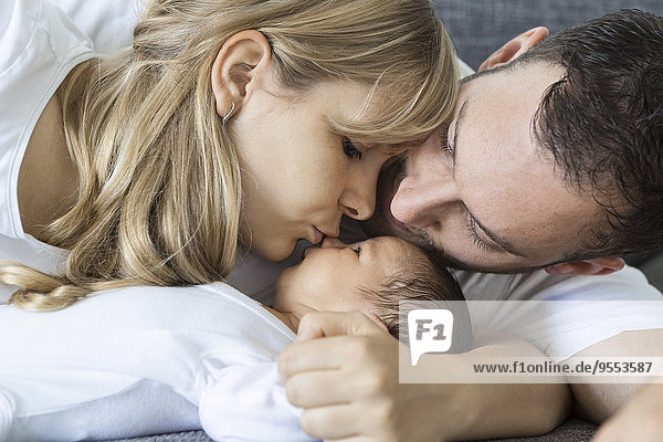 Young couple with newborn baby boy at home
