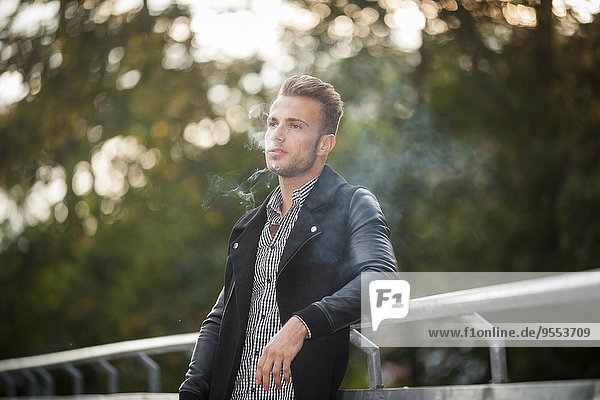Portrait of young man smoking a cigarette