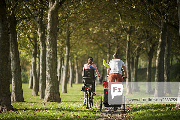 Family riding bicycle in park