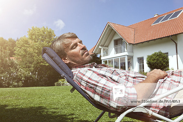 Relaxed man in deck chair in garden