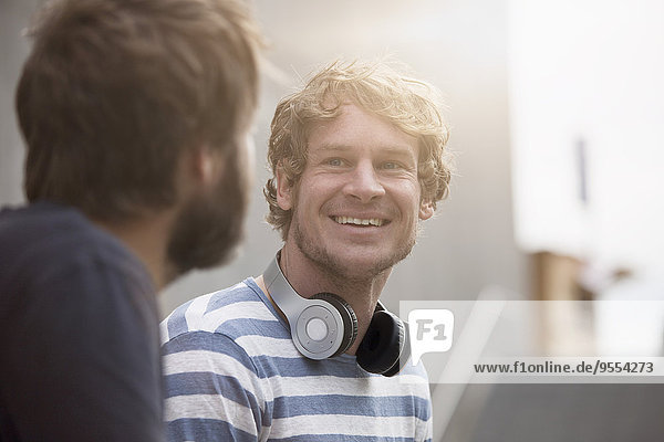 Portrait of smiling man communicating with a friend