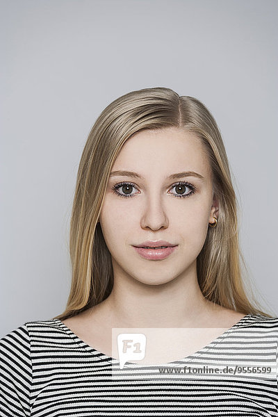 Portrait of young blond woman with brown eyes