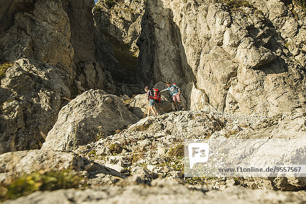 Austria  Tyrol  Tannheimer Tal  young couple hiking at rocks
