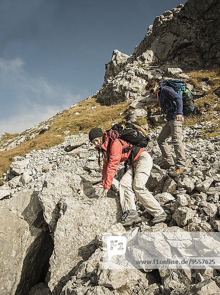 Austria  Tyrol  Tannheimer Tal  young couple hiking on rocks