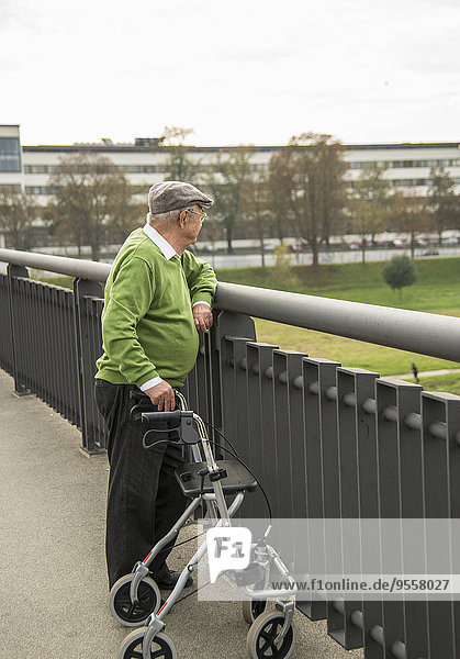 Senior mit Rollator auf der Brücke