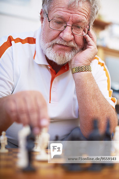 Älterer Mann beim Schachspielen