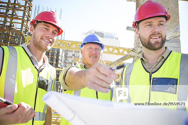 Three construction workers in construction site