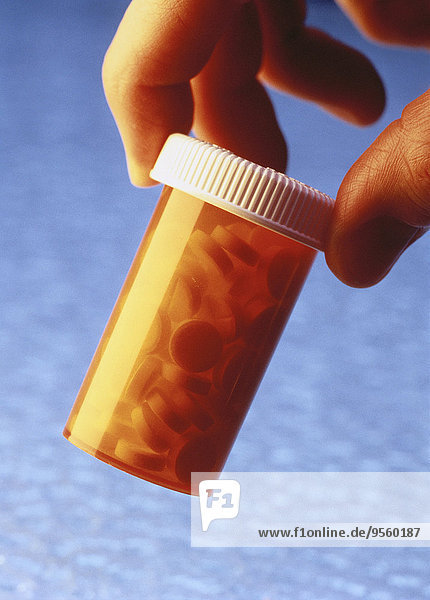 Close-Up of Hand Holding Pill Bottle
