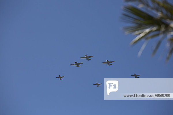 Low angle view of fighter planes against blue sky