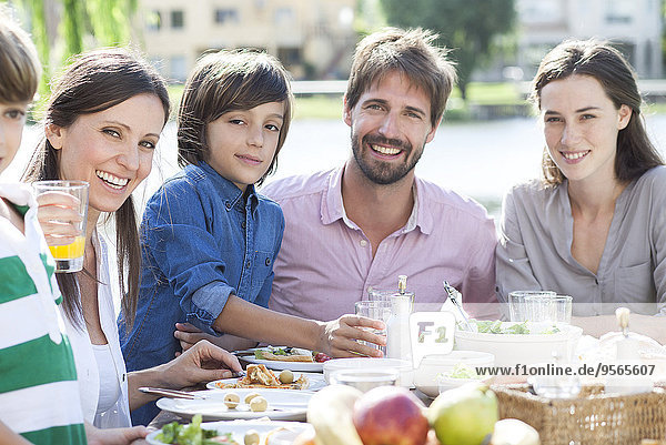 Family eating together outdoors  portrait