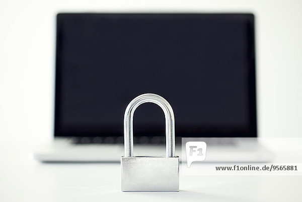 Padlock in front of laptop computer representing internet security