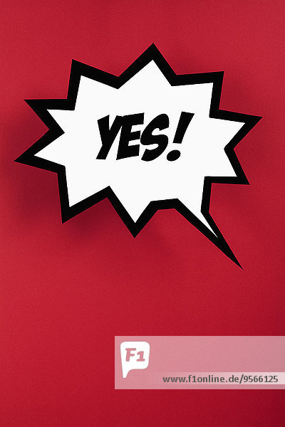 Exploding speech bubble with YES against red background