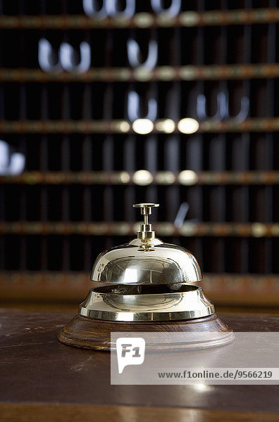 Brass bell on desk at hotel reception