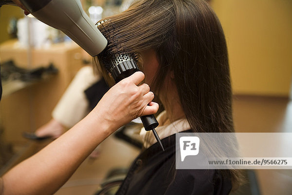 A woman having her hair styled at a salon