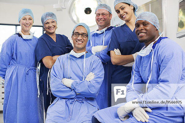 Group portrait of surgeons posing in operating theater
