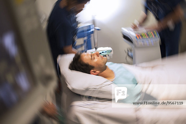 Blurred motion view of patient lying in bed in intensive care unit