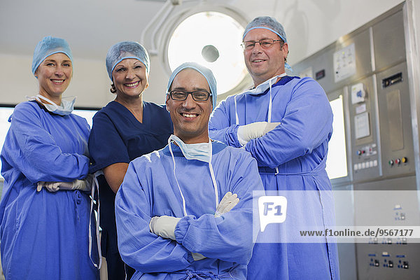 Team of doctors wearing surgical clothing in operating theater
