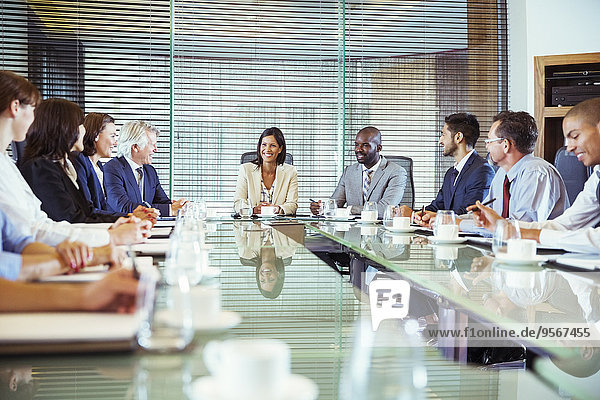 Business people having meeting in in conference room  smiling and discussing