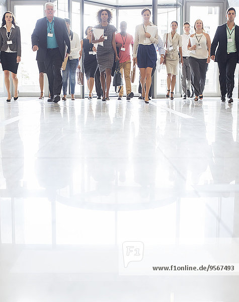 Large group of business people walking in office