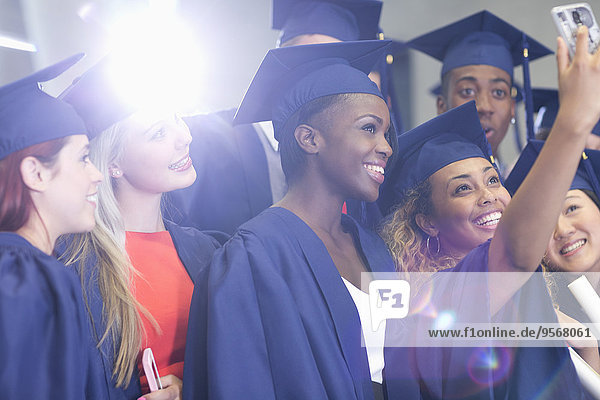 University students taking selfie in corridor after graduation ceremony
