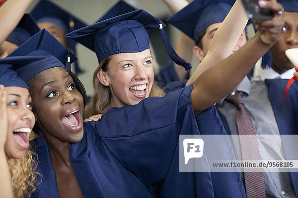 University students taking selfie after graduating
