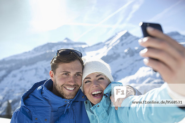 Couple taking selfie in snow