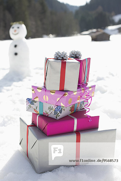 Stack of Christmas gifts in snow