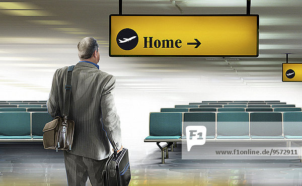 Geschäftsmann am Flughafen schaut auf Richtungsschild