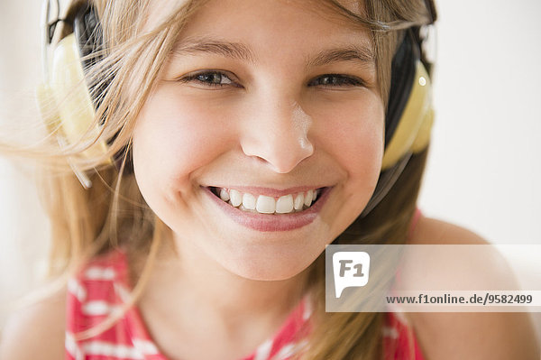 Close up of Caucasian girl wearing headphones