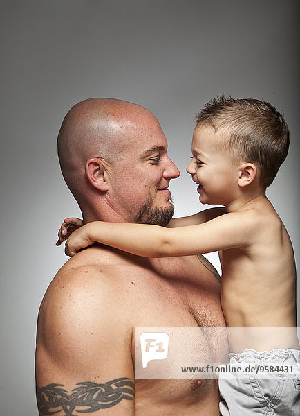 Caucasian father holding son