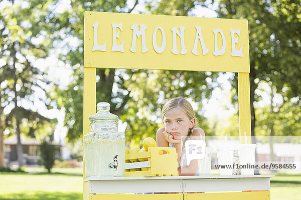 Bored Caucasian girl at lemonade stand
