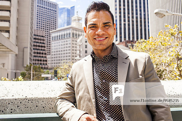 Hispanic businessman smiling in city