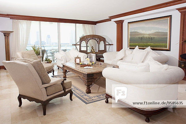 Sofas  armchairs and coffee table in ornate living room
