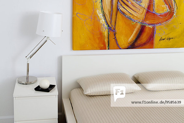 Lamp  wall art and bed in modern bedroom