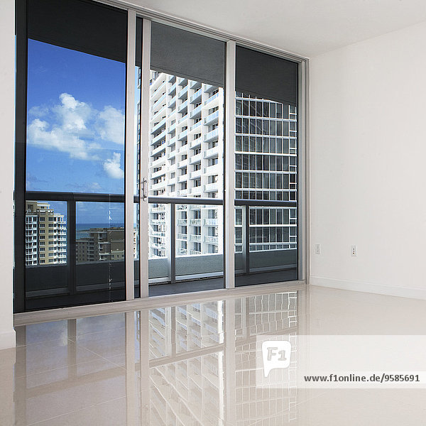 Glass doors and balcony of empty modern apartment