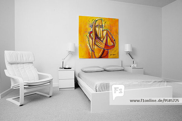 Chair  wall art and bed in modern bedroom