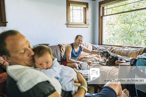 Caucasian fathers and baby boy relaxing in living room