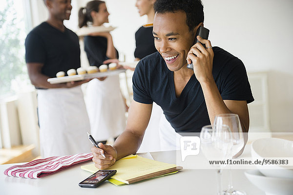 Caterer talking on phone in event space