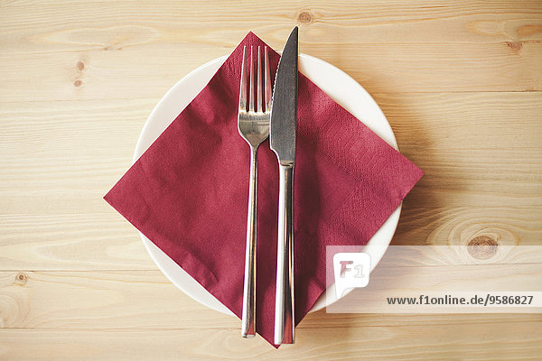 Close up of silverware  napkin and side plate