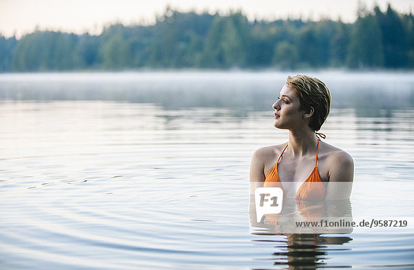 Caucasian woman swimming in still lake