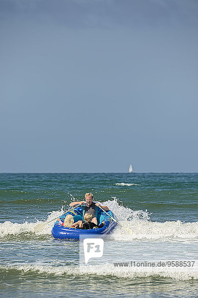 France  Brittany  Department Finistere  Sainte-Anne-la-Palud  Man with children in an inflatable boat