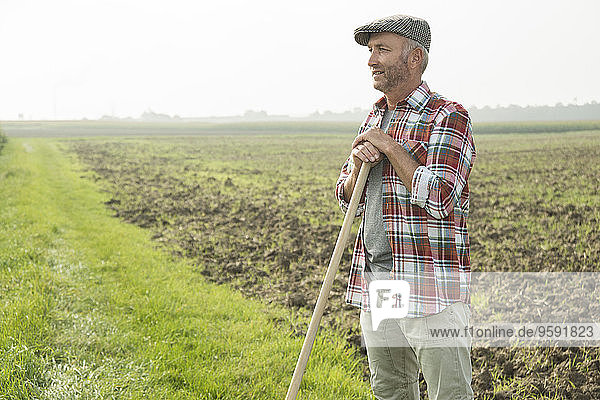 Farmer standing in front of a field