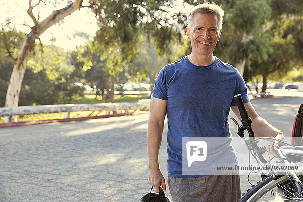 Portrait of mature male cyclist in park