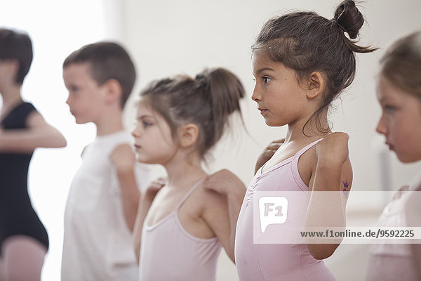 Row of children practicing in ballet school