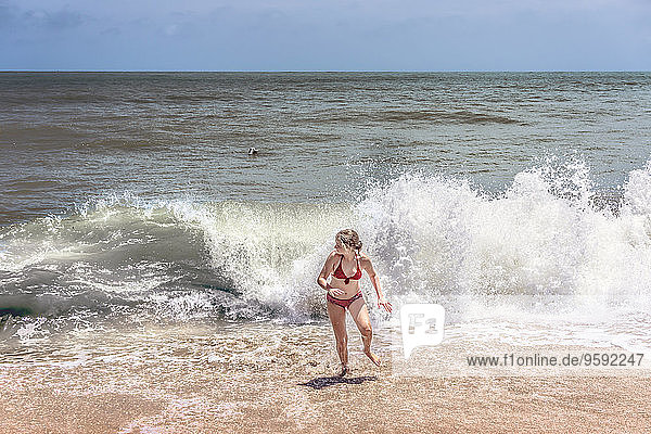 Thailand  Khao Lak  girl running out of water at Bang Niang Beach