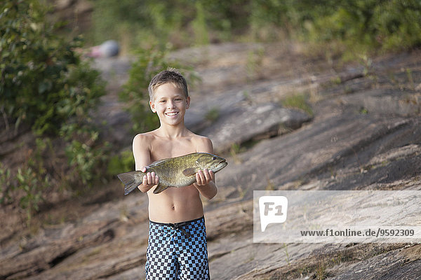Teenager-Junge hält Smallmouth Bass Fisch  Lake Superior  Au Train Bay  Michigan  USA