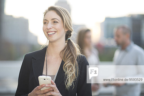 Portrait of smiling businesswoman with smartphone